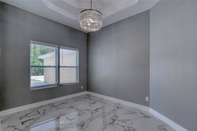 This newly remodeled 3-bedroom, 3-bathroom home in the desirable on The Grand Club - Pine Lakes Course in Florida - for sale on GolfHomes.com, golf home, golf lot