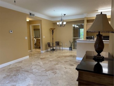 This spacious condo has updraded travertine tile throughout on Gateway Golf and Country Club in Florida - for sale on GolfHomes.com, golf home, golf lot
