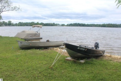 This beautifully maintained and updated home has 400 ft of on Elk Rapids Golf Club in Michigan - for sale on GolfHomes.com, golf home, golf lot