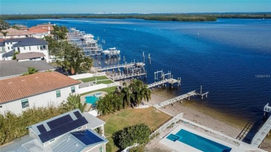 Discover unparalleled waterfront living with expansive views of on Mangrove Bay Golf Course in Florida - for sale on GolfHomes.com, golf home, golf lot