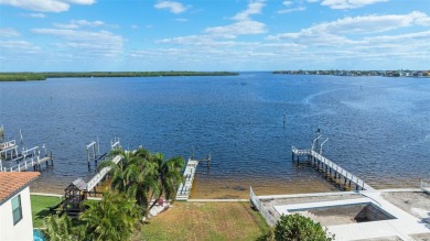 Discover unparalleled waterfront living with expansive views of on Mangrove Bay Golf Course in Florida - for sale on GolfHomes.com, golf home, golf lot