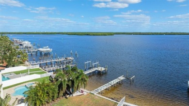 Discover unparalleled waterfront living with expansive views of on Mangrove Bay Golf Course in Florida - for sale on GolfHomes.com, golf home, golf lot