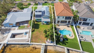 Discover unparalleled waterfront living with expansive views of on Mangrove Bay Golf Course in Florida - for sale on GolfHomes.com, golf home, golf lot