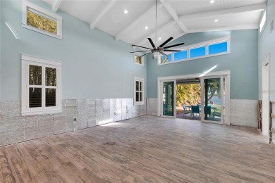 Discover unparalleled waterfront living with expansive views of on Mangrove Bay Golf Course in Florida - for sale on GolfHomes.com, golf home, golf lot