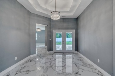 This newly remodeled 3-bedroom, 3-bathroom home in the desirable on The Grand Club - Pine Lakes Course in Florida - for sale on GolfHomes.com, golf home, golf lot