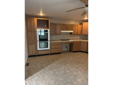 Don't miss this spacious 2,520 sq ft home located on 2.89 acres on The Pines Golf Course at Lake Isabella in Michigan - for sale on GolfHomes.com, golf home, golf lot