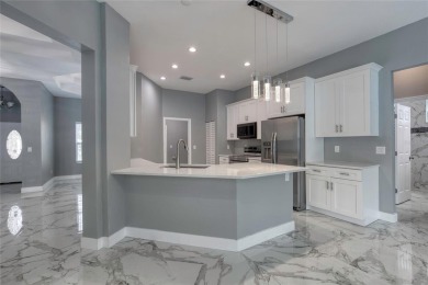 This newly remodeled 3-bedroom, 3-bathroom home in the desirable on The Grand Club - Pine Lakes Course in Florida - for sale on GolfHomes.com, golf home, golf lot