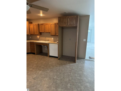 Don't miss this spacious 2,520 sq ft home located on 2.89 acres on The Pines Golf Course at Lake Isabella in Michigan - for sale on GolfHomes.com, golf home, golf lot