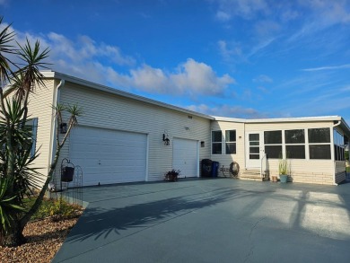 This garage is 32 feet by 22 feet, 2 separate doors, a 12-foot on Southport Springs Golf Club in Florida - for sale on GolfHomes.com, golf home, golf lot