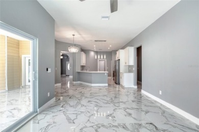 This newly remodeled 3-bedroom, 3-bathroom home in the desirable on The Grand Club - Pine Lakes Course in Florida - for sale on GolfHomes.com, golf home, golf lot
