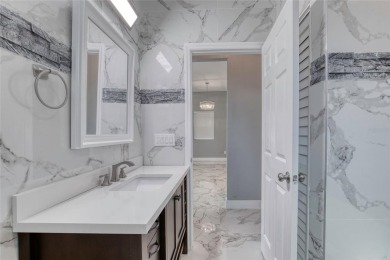 This newly remodeled 3-bedroom, 3-bathroom home in the desirable on The Grand Club - Pine Lakes Course in Florida - for sale on GolfHomes.com, golf home, golf lot