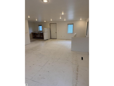 Don't miss this spacious 2,520 sq ft home located on 2.89 acres on The Pines Golf Course at Lake Isabella in Michigan - for sale on GolfHomes.com, golf home, golf lot