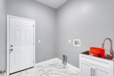 This newly remodeled 3-bedroom, 3-bathroom home in the desirable on The Grand Club - Pine Lakes Course in Florida - for sale on GolfHomes.com, golf home, golf lot