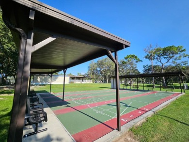 This garage is 32 feet by 22 feet, 2 separate doors, a 12-foot on Southport Springs Golf Club in Florida - for sale on GolfHomes.com, golf home, golf lot