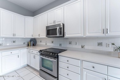 Tucked along a tranquil lagoon inside the prestigious on Jacksonville Golf and Country Club in Florida - for sale on GolfHomes.com, golf home, golf lot