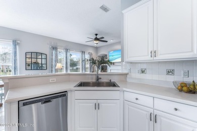 Tucked along a tranquil lagoon inside the prestigious on Jacksonville Golf and Country Club in Florida - for sale on GolfHomes.com, golf home, golf lot