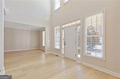 Beautiful traditional-style home with a rocking chair front on Canongate At Olde Atlanta Golf Club in Georgia - for sale on GolfHomes.com, golf home, golf lot