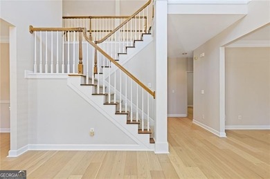 Beautiful traditional-style home with a rocking chair front on Canongate At Olde Atlanta Golf Club in Georgia - for sale on GolfHomes.com, golf home, golf lot