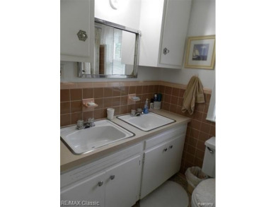Nestled near the scenic Western Golf Course, this beautifully on Western Golf and Country Club in Michigan - for sale on GolfHomes.com, golf home, golf lot