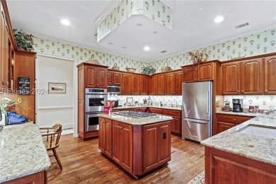 Enjoy the peaceful enlarged screen porch of this classic Belfair on Belfair Golf Club in South Carolina - for sale on GolfHomes.com, golf home, golf lot