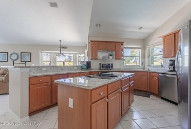 Welcome to your dream home! Nestled on a prestigious Viera East on Viera East Golf Club in Florida - for sale on GolfHomes.com, golf home, golf lot