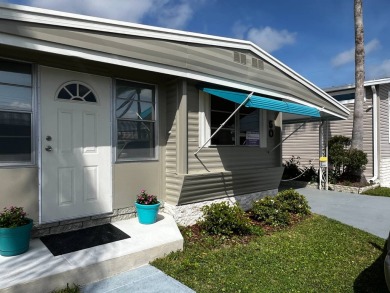 JUST REDUCED! Charming, partially furnished, two-bedroom on The Dunedin Country Club in Florida - for sale on GolfHomes.com, golf home, golf lot