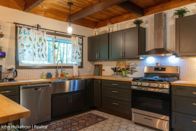 Welcome to this distinctive four-bedroom, three-bath chalet on Canadian Lakes Country Club-The Royal Course in Michigan - for sale on GolfHomes.com, golf home, golf lot