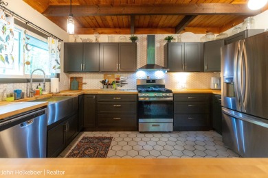 Welcome to this distinctive four-bedroom, three-bath chalet on Canadian Lakes Country Club-The Royal Course in Michigan - for sale on GolfHomes.com, golf home, golf lot