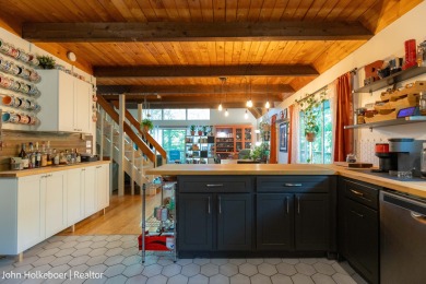 Welcome to this distinctive four-bedroom, three-bath chalet on Canadian Lakes Country Club-The Royal Course in Michigan - for sale on GolfHomes.com, golf home, golf lot