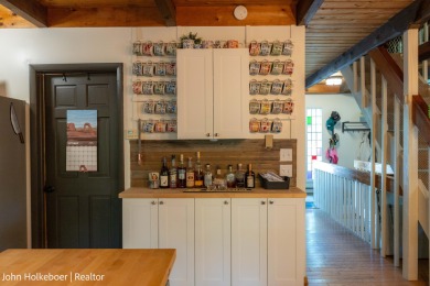 Welcome to this distinctive four-bedroom, three-bath chalet on Canadian Lakes Country Club-The Royal Course in Michigan - for sale on GolfHomes.com, golf home, golf lot