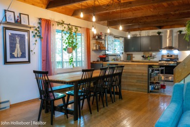 Welcome to this distinctive four-bedroom, three-bath chalet on Canadian Lakes Country Club-The Royal Course in Michigan - for sale on GolfHomes.com, golf home, golf lot