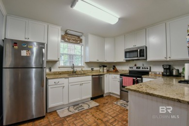 This charming single-story cottage features 3 bedrooms and 2 on Lake Forest Yacht and Country Club in Alabama - for sale on GolfHomes.com, golf home, golf lot