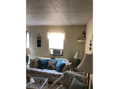 Cozy cottage with open floor plan and beachy feel.  Fully on Captains Cove Golf and Yacht Club in Virginia - for sale on GolfHomes.com, golf home, golf lot