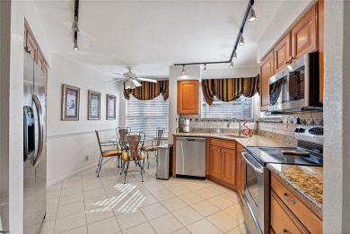 Relaxing is easy from this ideally located golf course condo in on Isla Del Sol Yacht and Country Club in Florida - for sale on GolfHomes.com, golf home, golf lot
