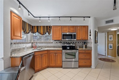 Relaxing is easy from this ideally located golf course condo in on Isla Del Sol Yacht and Country Club in Florida - for sale on GolfHomes.com, golf home, golf lot