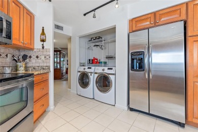 Relaxing is easy from this ideally located golf course condo in on Isla Del Sol Yacht and Country Club in Florida - for sale on GolfHomes.com, golf home, golf lot