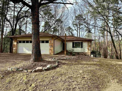 Nestled in the tress, this Hot Springs Village home is situated on DeSoto Golf Course in Arkansas - for sale on GolfHomes.com, golf home, golf lot