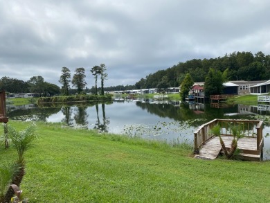 THIS LAKEFRONT COTTAGE STYLE HOME IN AN ALL AGES COMMUNITY WILL on Silver Dollar Golf and Trap Club in Florida - for sale on GolfHomes.com, golf home, golf lot