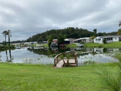 THIS LAKEFRONT COTTAGE STYLE HOME IN AN ALL AGES COMMUNITY WILL on Silver Dollar Golf and Trap Club in Florida - for sale on GolfHomes.com, golf home, golf lot