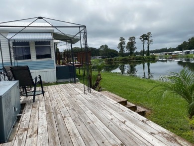 THIS LAKEFRONT COTTAGE STYLE HOME IN AN ALL AGES COMMUNITY WILL on Silver Dollar Golf and Trap Club in Florida - for sale on GolfHomes.com, golf home, golf lot