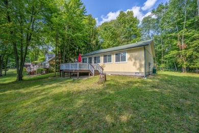 Discover the epitome of tranquility with this charming on Canadian Lakes Country Club-The Highlands Course in Michigan - for sale on GolfHomes.com, golf home, golf lot