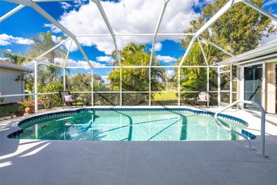 A Poolside Retreat with Peaceful Canal Views in Rotonda West's on Pinemoor West Golf Club in Florida - for sale on GolfHomes.com, golf home, golf lot