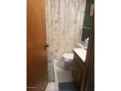 Tucked away on a wooded double-parcel lot, this exceptional on Redwood Falls Golf Club in Minnesota - for sale on GolfHomes.com, golf home, golf lot