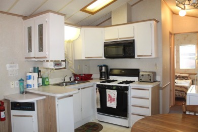 This 2 bedroom 1.5 bath Chariot Eagle Park Model with attached on Indian Mound Golf Club in New Hampshire - for sale on GolfHomes.com, golf home, golf lot