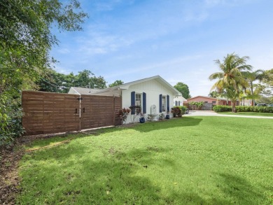 THIS SPACIOUS 4 BEDROOM/2 BATH HOME WITH A LARGE SCREENED IN on Tequesta Country Club in Florida - for sale on GolfHomes.com, golf home, golf lot