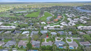 THIS SPACIOUS 4 BEDROOM/2 BATH HOME WITH A LARGE SCREENED IN on Tequesta Country Club in Florida - for sale on GolfHomes.com, golf home, golf lot