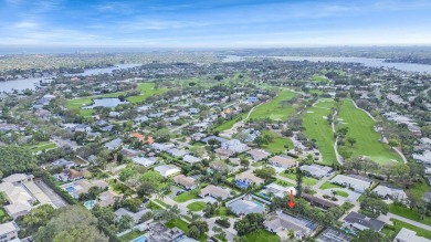 THIS SPACIOUS 4 BEDROOM/2 BATH HOME WITH A LARGE SCREENED IN on Tequesta Country Club in Florida - for sale on GolfHomes.com, golf home, golf lot