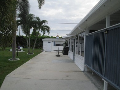 HUGE CORNER LOT PROPERTY WITH A PRIVATE DOCK & WITH A BEAUTIFUL on Cypress Creek Country Club - Boynton Beach in Florida - for sale on GolfHomes.com, golf home, golf lot