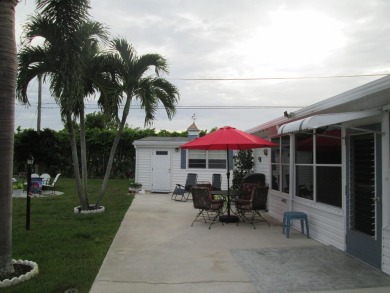 HUGE CORNER LOT PROPERTY WITH A PRIVATE DOCK & WITH A BEAUTIFUL on Cypress Creek Country Club - Boynton Beach in Florida - for sale on GolfHomes.com, golf home, golf lot