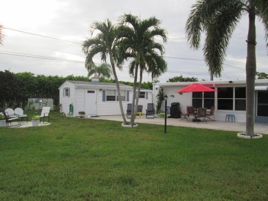HUGE CORNER LOT PROPERTY WITH A PRIVATE DOCK & WITH A BEAUTIFUL on Cypress Creek Country Club - Boynton Beach in Florida - for sale on GolfHomes.com, golf home, golf lot